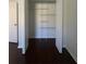 Spacious walk-in closet with white shelving and dark laminate flooring at 30142 Sotogrande Loop, Wesley Chapel, FL 33543