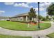 Well-maintained home showcasing a landscaped front yard, covered porch, and mature trees at 30142 Sotogrande Loop, Wesley Chapel, FL 33543
