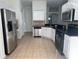 Well-equipped kitchen with stainless steel appliances and white cabinets, providing a modern aesthetic at 30142 Sotogrande Loop, Wesley Chapel, FL 33543