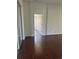 Living room showcases an archway and laminate wood flooring at 30142 Sotogrande Loop, Wesley Chapel, FL 33543