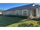 Side view of a home with a well-maintained lawn and manicured bushes at 30142 Sotogrande Loop, Wesley Chapel, FL 33543