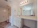 Bathroom featuring a sink vanity with a large mirror, tile flooring, and a separate toilet and tub/shower room at 3389 Crystal E Ct # M, Palm Harbor, FL 34685