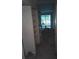 Living room with sliding glass door, ceiling fan, and boxes of flooring material at 3801 N Oak Dr # A62, Tampa, FL 33611