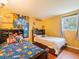 Bright bedroom featuring two beds, and playful Mario-themed decor on the walls and curtains at 39111 3Rd Ave, Zephyrhills, FL 33542