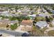 Aerial view of a home with a big front yard and a neighboring community at 4209 Westwood Dr, Holiday, FL 34691