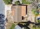 Overhead aerial view of a single-Gathering home with a brown roof and a spacious, but overgrown, yard at 4209 Westwood Dr, Holiday, FL 34691