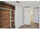 Bedroom with closet, closet system, wood-look flooring, and white trim at 4209 Westwood Dr, Holiday, FL 34691