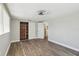 Bedroom with closet, closet system, wood-look flooring, and a ceiling fan at 4209 Westwood Dr, Holiday, FL 34691