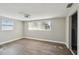 Bright bedroom features wood floors, a ceiling fan, and two windows, creating a comfortable retreat at 4209 Westwood Dr, Holiday, FL 34691