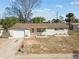Single-story home featuring an attached garage and a cozy, inviting entrance at 4209 Westwood Dr, Holiday, FL 34691