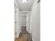 Hallway with wood floors leading to rooms with white doors at 4209 Westwood Dr, Holiday, FL 34691