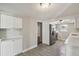 Bright kitchen featuring white cabinets, stainless steel appliances, and tile flooring, a modern design at 4209 Westwood Dr, Holiday, FL 34691