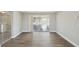 Open living space featuring modern flooring, sliding glass doors to sunroom, and neutral paint at 4209 Westwood Dr, Holiday, FL 34691