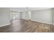 Bright living room with modern flooring, freshly painted walls, and a view of the outdoors at 4209 Westwood Dr, Holiday, FL 34691
