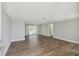 Spacious living room featuring modern gray walls, vinyl flooring, and sliding glass doors at 4209 Westwood Dr, Holiday, FL 34691