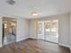 Bright living room boasts wood floors, sliding glass doors to an enclosed porch, and an open layout at 4209 Westwood Dr, Holiday, FL 34691