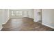 Spacious living room with wood floors, a bright window, and neutral paint, creating a comfortable space at 4209 Westwood Dr, Holiday, FL 34691