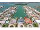 Aerial view of a canal front home with a private boat dock; nearby islands are visible in the distance at 440 Capri Blvd, Treasure Island, FL 33706