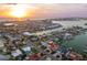 Stunning aerial view of the waterfront property with a pool, dock, and boat, offering a prime coastal lifestyle at 440 Capri Blvd, Treasure Island, FL 33706