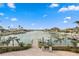 Picturesque backyard featuring a canal view, dock, and outdoor seating area, perfect for waterfront living at 440 Capri Blvd, Treasure Island, FL 33706