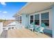 Charming balcony showcasing outdoor seating and scenic views under a bright blue sky, perfect for relaxation and enjoying the outdoors at 440 Capri Blvd, Treasure Island, FL 33706