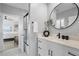 Bright bathroom with white cabinets, modern fixtures, an elegant vanity, and an open doorway to the bedroom at 440 Capri Blvd, Treasure Island, FL 33706