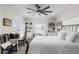 Inviting bedroom with a cozy window seat, built-in bookcases, desk, and a comfortable wrought iron bed at 440 Capri Blvd, Treasure Island, FL 33706