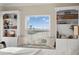 Comfortable bedroom with a cozy window seat, built-in bookcases, and serene view at 440 Capri Blvd, Treasure Island, FL 33706