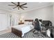 Comfortable bedroom with a ceiling fan, a large bed, a workstation, and an en suite bathroom at 440 Capri Blvd, Treasure Island, FL 33706