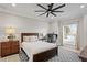 Cozy bedroom featuring a large bed, neutral tones, a stylish rug, and dedicated workspace area with a computer at 440 Capri Blvd, Treasure Island, FL 33706