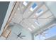 High ceiling showcasing multiple skylights, decorative beams, and ceiling fans at 440 Capri Blvd, Treasure Island, FL 33706