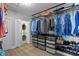 Organized closet with custom shelving, hanging racks, clear storage drawers, and convenient in-unit stackable washer and dryer at 440 Capri Blvd, Treasure Island, FL 33706
