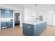 Modern kitchen featuring an island with marble countertops, shaker cabinets and stainless steel appliances at 440 Capri Blvd, Treasure Island, FL 33706
