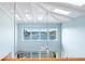 Light-filled living room boasts vaulted ceilings, large windows with stunning views, and access to an outdoor pool at 440 Capri Blvd, Treasure Island, FL 33706