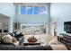 Living room featuring cathedral ceilings, oversized windows with water views, and sliding doors to a deck at 440 Capri Blvd, Treasure Island, FL 33706