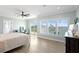 Inviting main bedroom features wide plank flooring, ample natural light, and access to private balcony at 440 Capri Blvd, Treasure Island, FL 33706