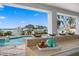 Outdoor bar near pool overlooks a tranquil waterfront view with ample sunshine and lush landscaping at 440 Capri Blvd, Treasure Island, FL 33706