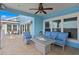 Outdoor living area on a patio with comfortable seating, fire table, and an overhead ceiling fan at 440 Capri Blvd, Treasure Island, FL 33706