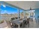 Outdoor dining area on the porch with seating for eight overlooks the water at 440 Capri Blvd, Treasure Island, FL 33706
