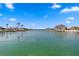 Scenic canal view with lush landscaping, docks, and beautiful blue skies, ideal for boating enthusiasts at 440 Capri Blvd, Treasure Island, FL 33706