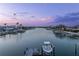 Beautiful canal view at twilight, complete with a private dock, boat lift, and serene waterfront setting at 440 Capri Blvd, Treasure Island, FL 33706