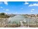 Breathtaking waterfront view from balcony featuring lush landscaping, docks, and calm waters under a clear sky at 440 Capri Blvd, Treasure Island, FL 33706