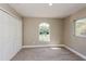 Bedroom featuring neutral carpet, double closet, and two windows letting in natural light at 4418 Mocha Ave, North Port, FL 34287