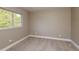 Bedroom with neutral carpet, white trim, and a window view to the outdoors at 4418 Mocha Ave, North Port, FL 34287