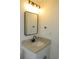 Bathroom features a granite countertop vanity with modern black plumbing fixtures and a matching black framed mirror at 4517 100Th N Ave, Pinellas Park, FL 33782