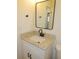 Bathroom featuring granite counter top, black faucet, and updated mirror at 4517 100Th N Ave, Pinellas Park, FL 33782