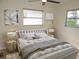 Cozy bedroom featuring a ceiling fan, comfortable bed, and lots of natural light at 4517 100Th N Ave, Pinellas Park, FL 33782