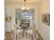 Elegant dining area with a glass table, seating for four, and a stylish chandelier, perfect for entertaining at 4517 100Th N Ave, Pinellas Park, FL 33782