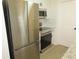 Modern kitchen with stainless steel appliances, white cabinetry, and stylish fixtures at 4517 100Th N Ave, Pinellas Park, FL 33782