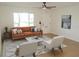 Inviting living room with stylish furniture, modern rug, and large front window at 4517 100Th N Ave, Pinellas Park, FL 33782